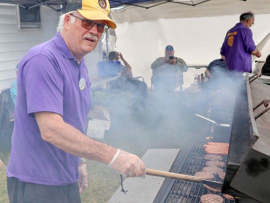 Flipping burgers for the Babbitt Lions Club was